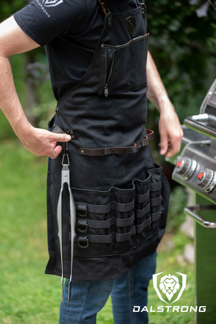 A man wearing the Dalstrong heavy-duty waxed canvas bbq apron.