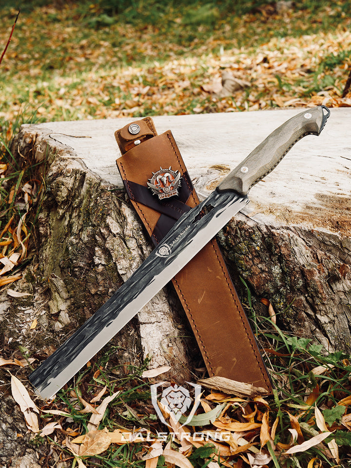 Dalstrong barbarian series 12 inch carving knife with wooden handle and sheath beside a log.