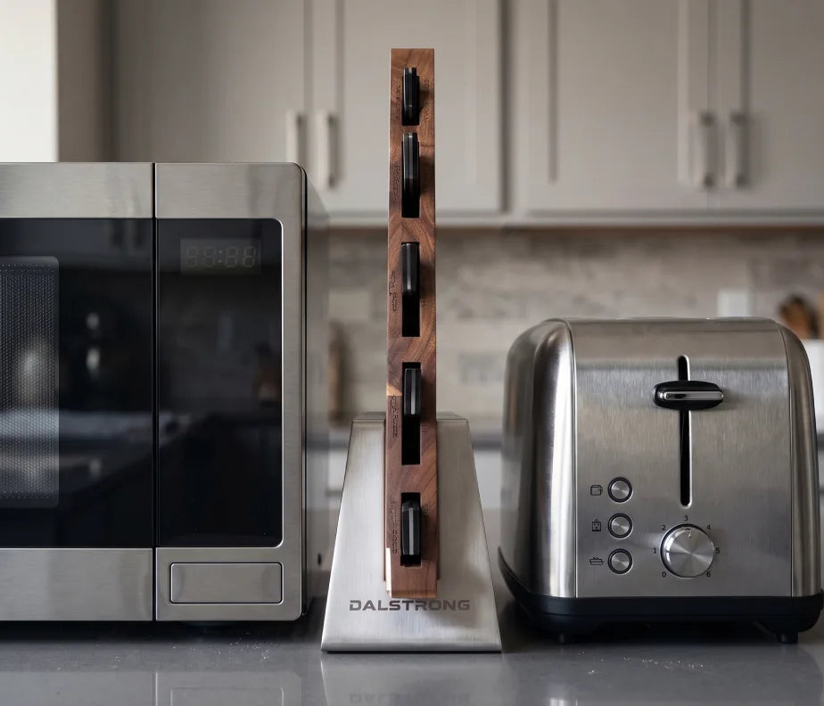 <h6>Slides in where nothing else will.</h6><p>At 24mm the acacia block takes almost nothing off your counter. Slot it between the microwave and the wall, stand it beside your boards, tuck it into the gap a traditional block would never clear. The space you already have is enough.</p>