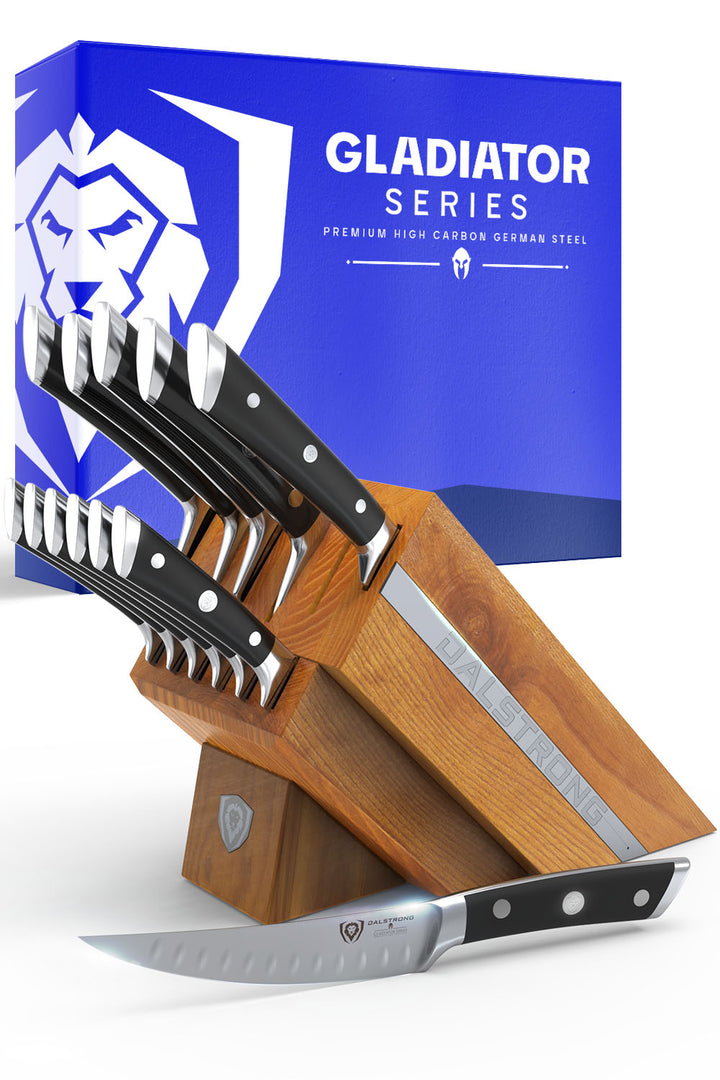 Dalstrong gladiator series 12 piece knife block set with black handles in front of it's premium packaging.