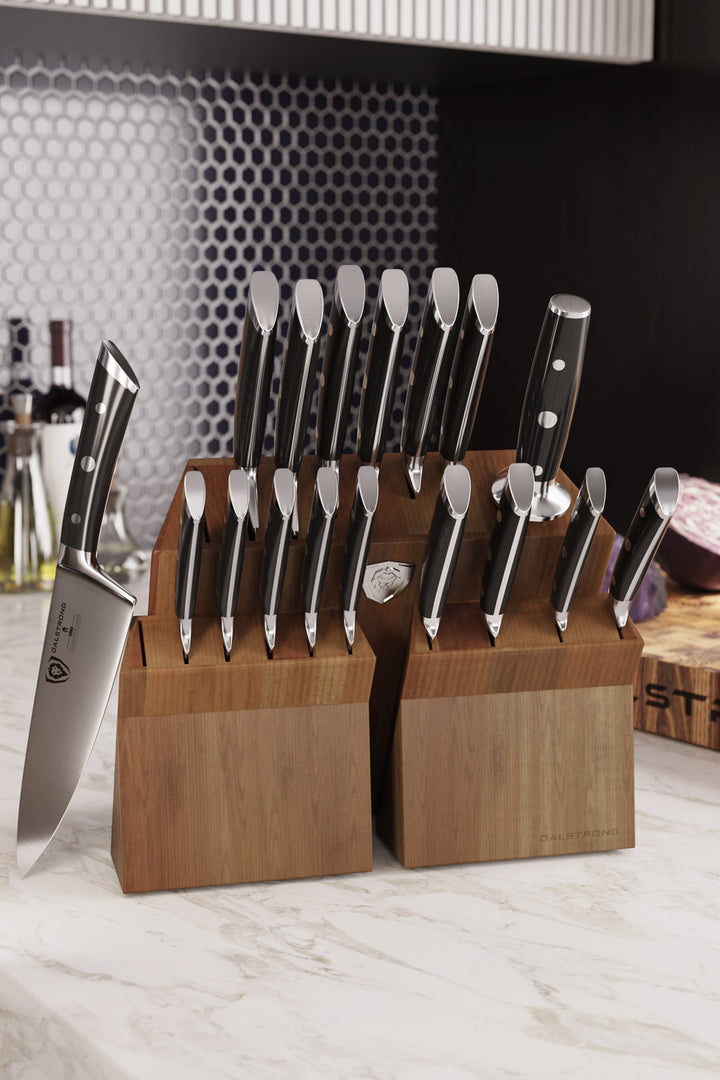 Dalstrong gladiator series 18 piece knife set with black handles and block on the kitchen table.