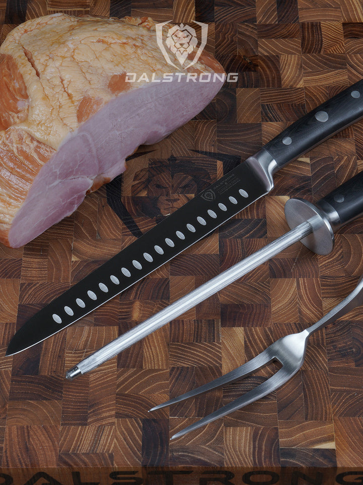 Dalstrong gladiator series 9 inch carving knife and fork set beside a huge cut of meat on a wooden table.