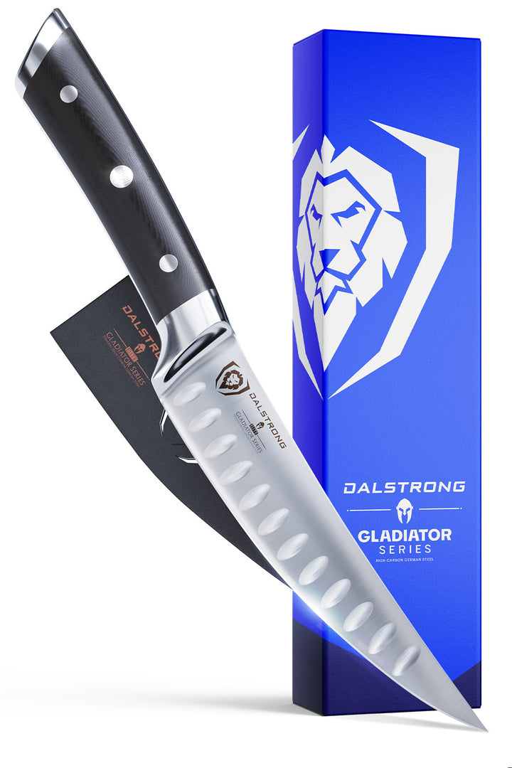 Dalstrong gladiator series 6 inch curved fillet knife with black handle in front of it's premium packaging.