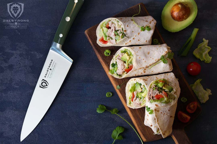 Dalstrong gladiator series 8 inch chef knife with green handle and four pieces of chicken and avocado rolls.