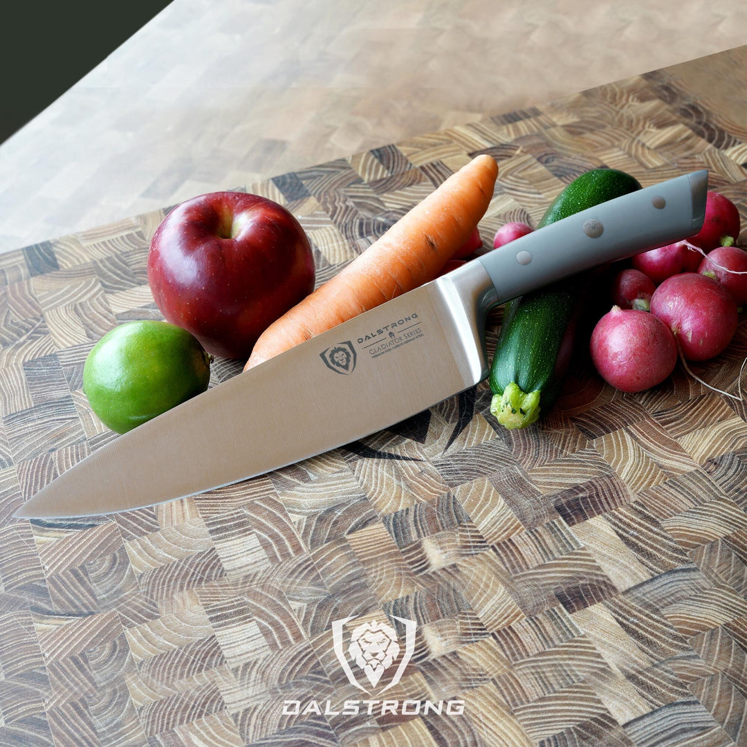 Dalstrong gladiator series 8 inch chef knife with grey handle beside some fruits and vegetables.