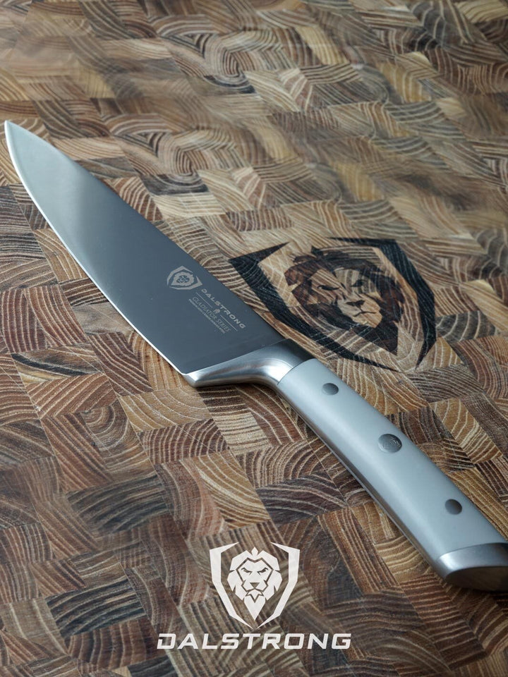 Dalstrong gladiator series 8 inch chef knife with grey handle in top of a dalstrong cutting board.