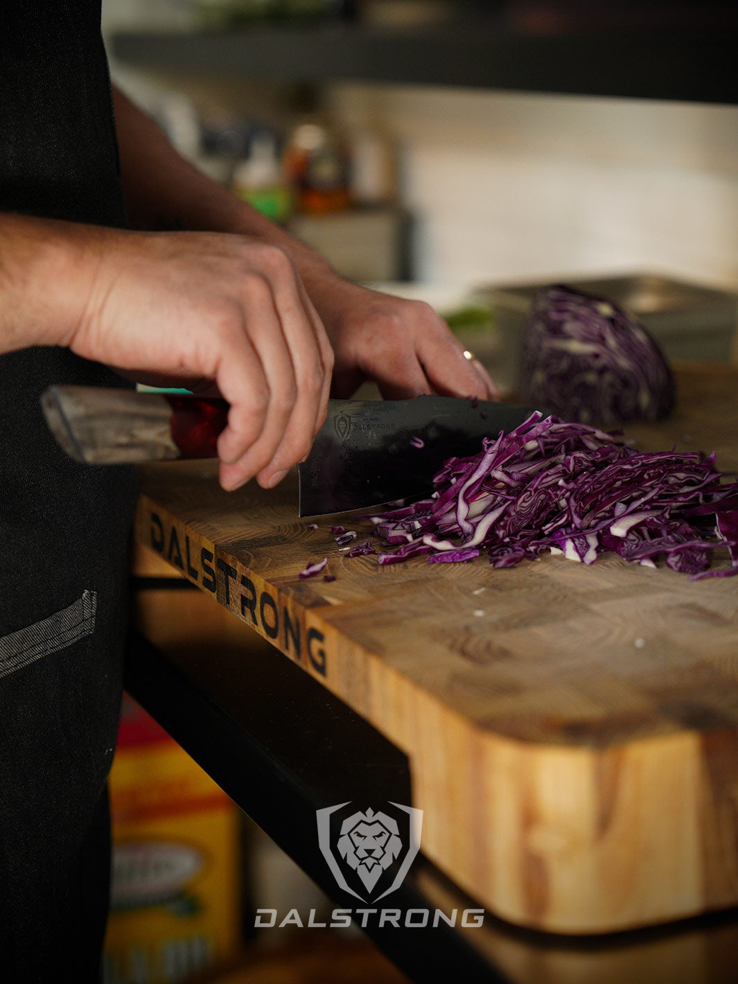 Dalstrong spartan ghost series 8 inch chef knife with a chopped violet cabbage on a cutting board.