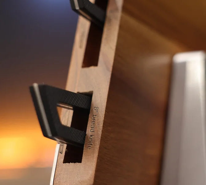 Close-up of Arro knife handles seated in the block’s labeled slots