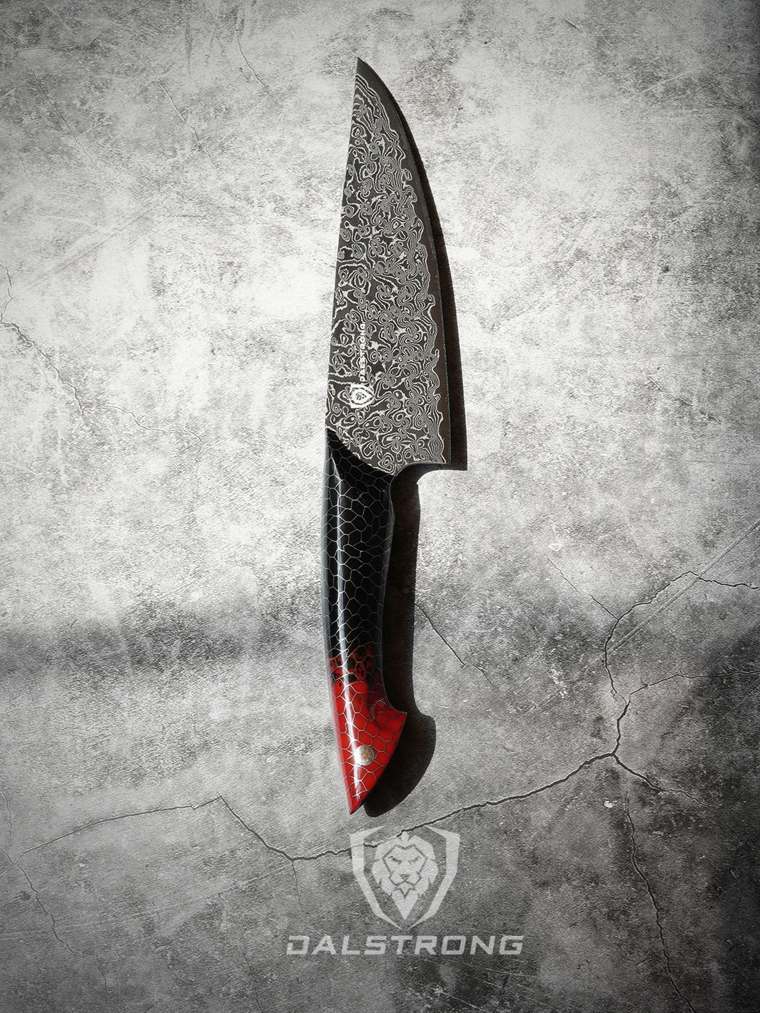 Dalstrong scorpion series 8 inch chef knife with red handle on a rough surface.