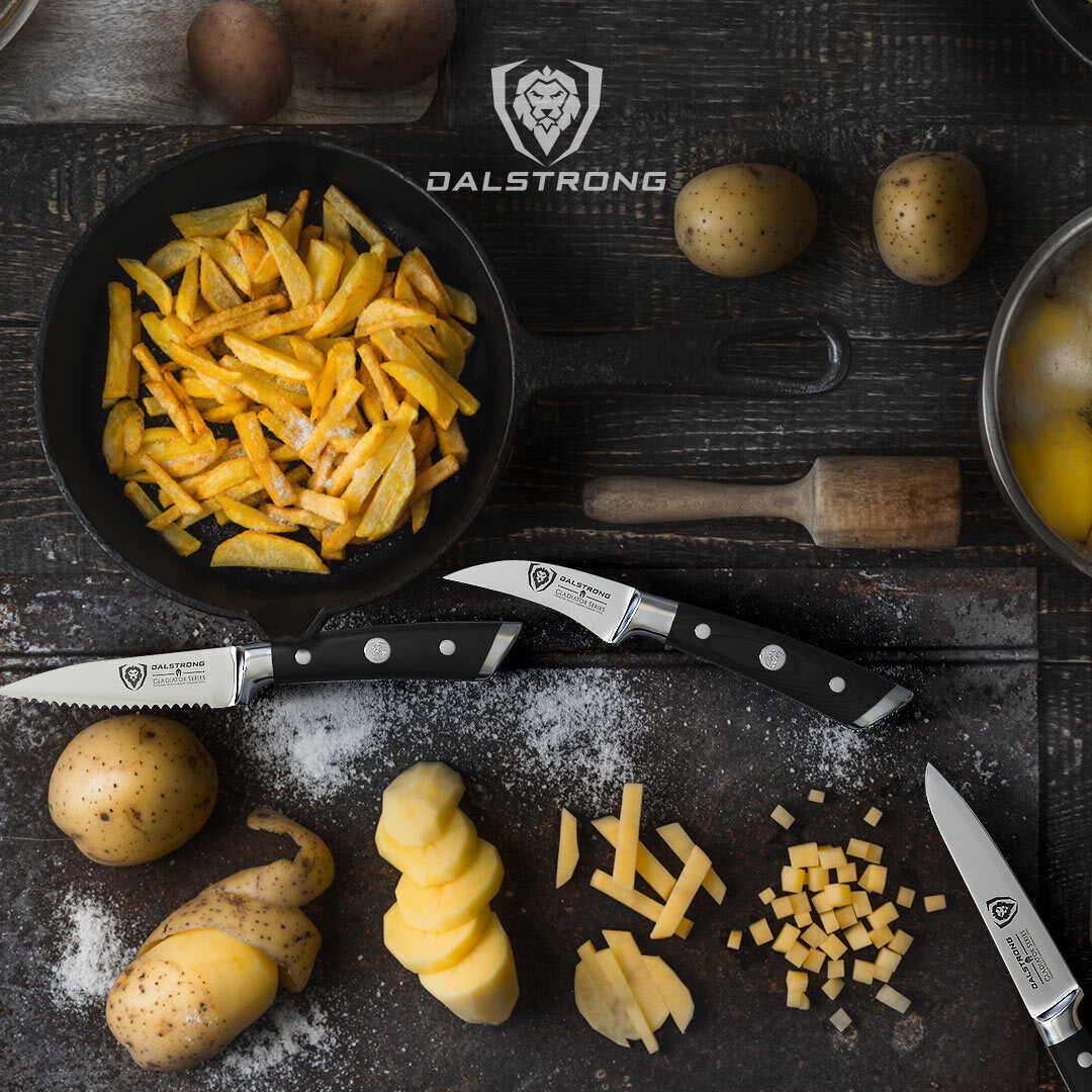 Dalstrong gladiator series 3 piece paring knife set with black handles and different cuts of potatoes.