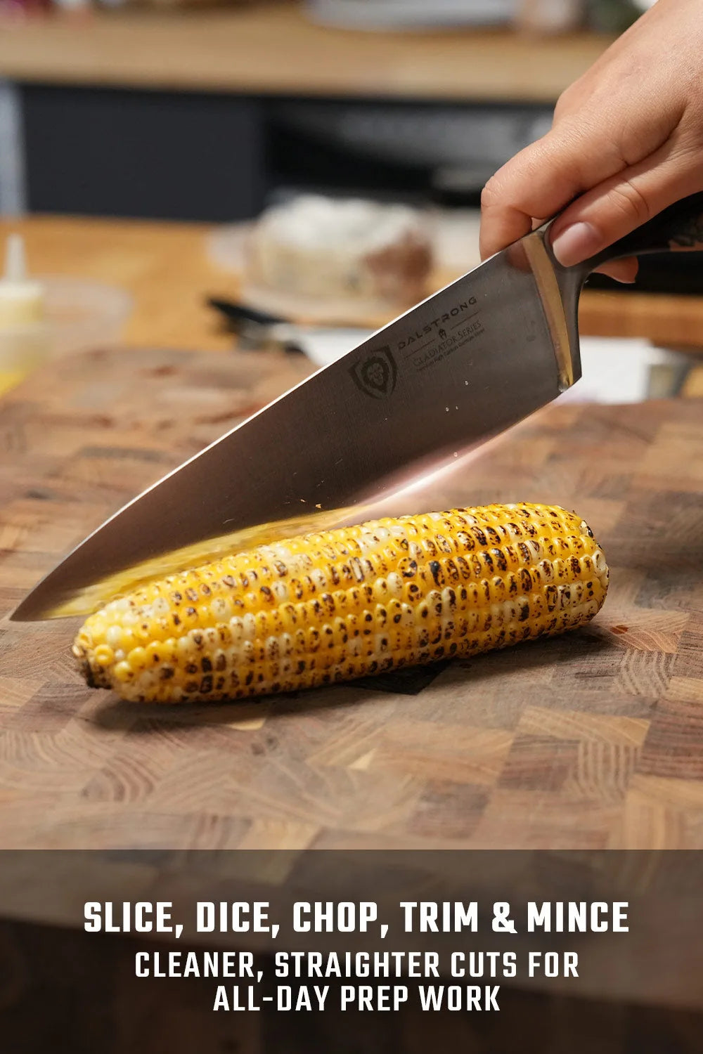 A cook using the Gladiator 10-inch chef’s knife to cut corn on a wooden board
