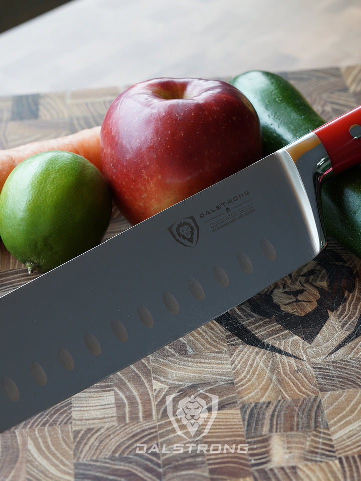 Dasltrong gladiator series 7 inch nakiri knife with red handle and fruits on a cutting board.