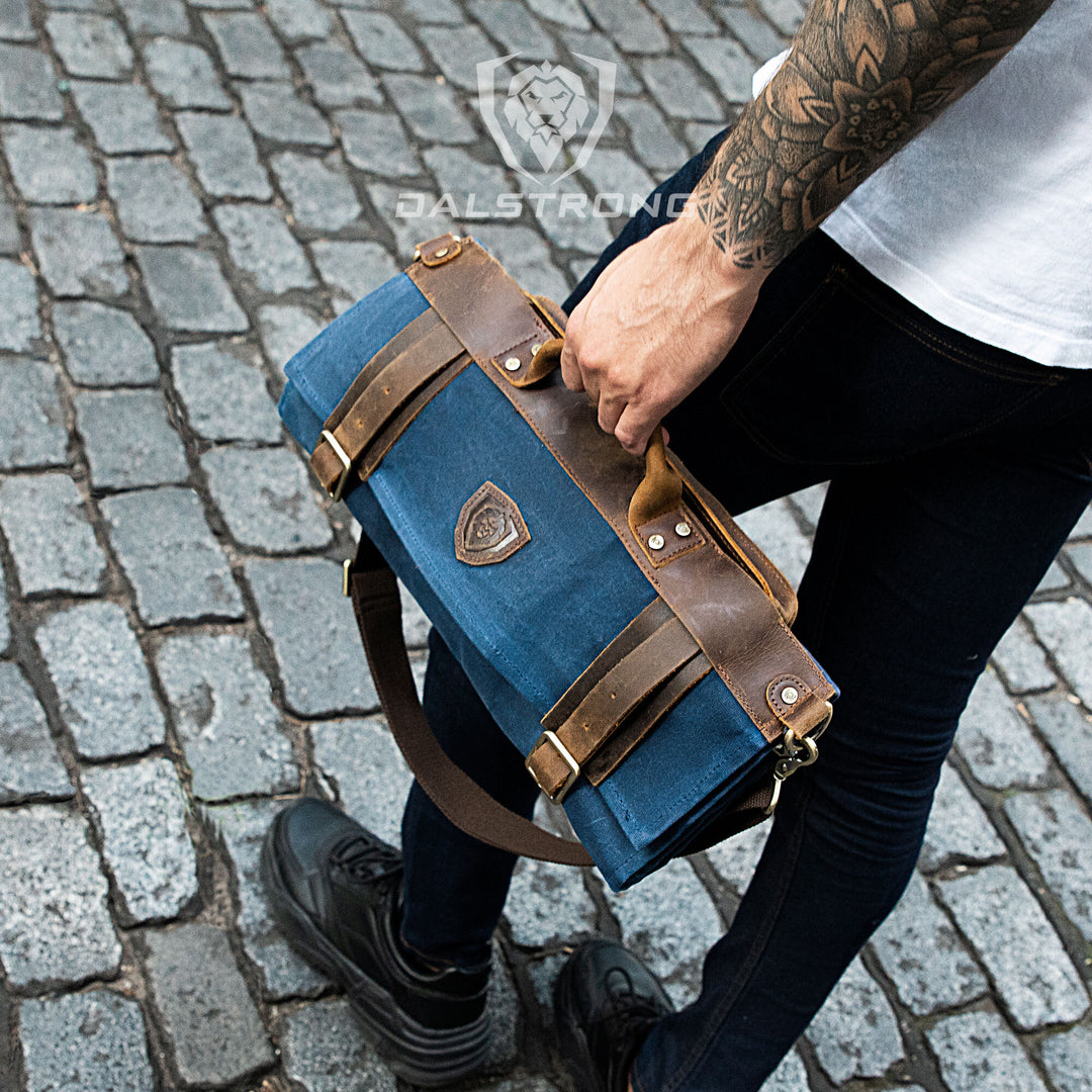 A man holding the Dalstrong 12oz heavy-duty canvas and leather blue nomad knife roll.