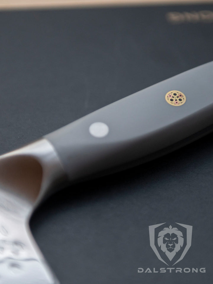 Dalstrong shogun series 8 inch chef knife with gray matte handle on a solid surface.