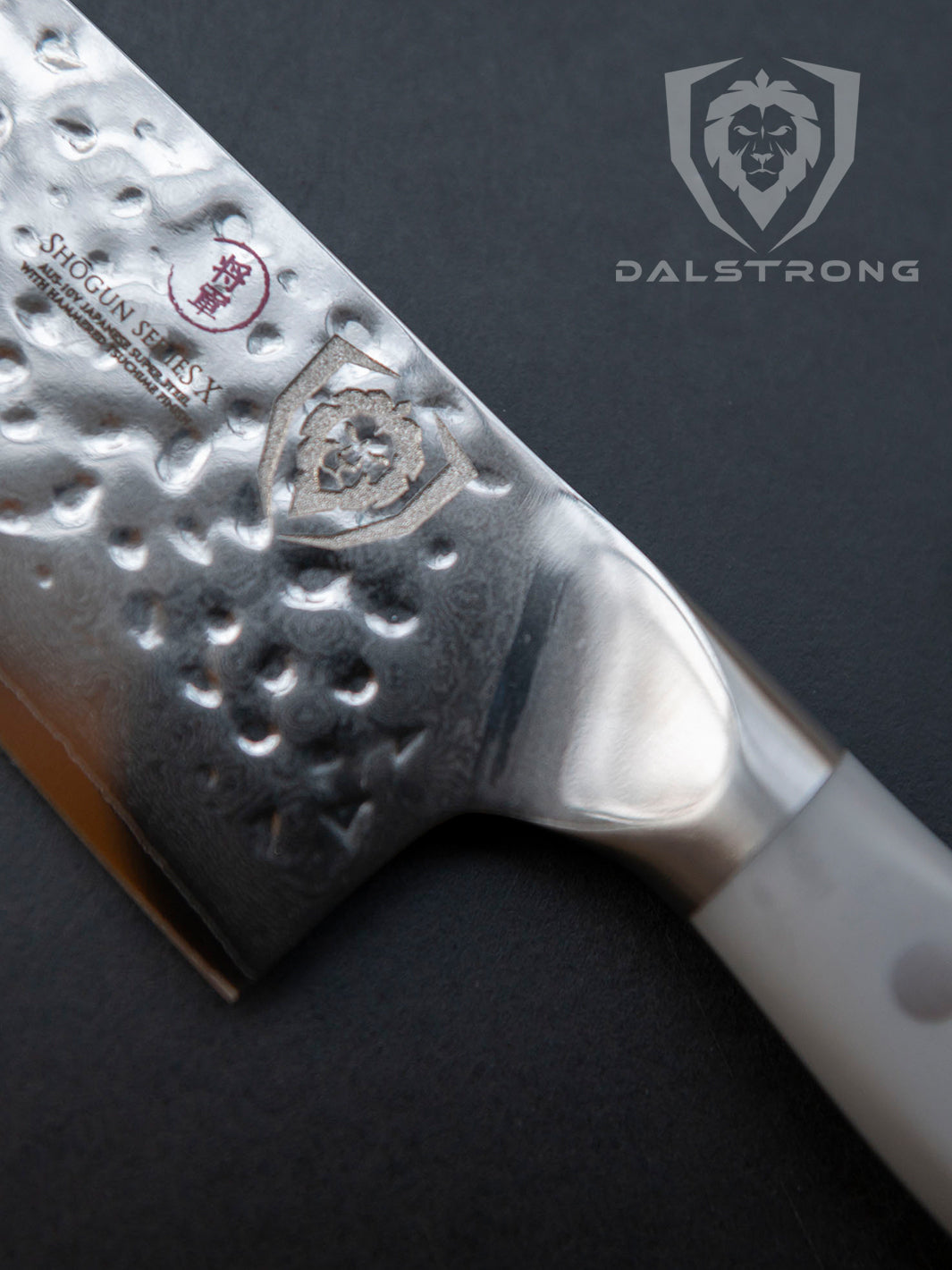 Dalstrong shogun series 8 inch chef knife with gray matte handle and logo of Dalstrong on a solid surface.