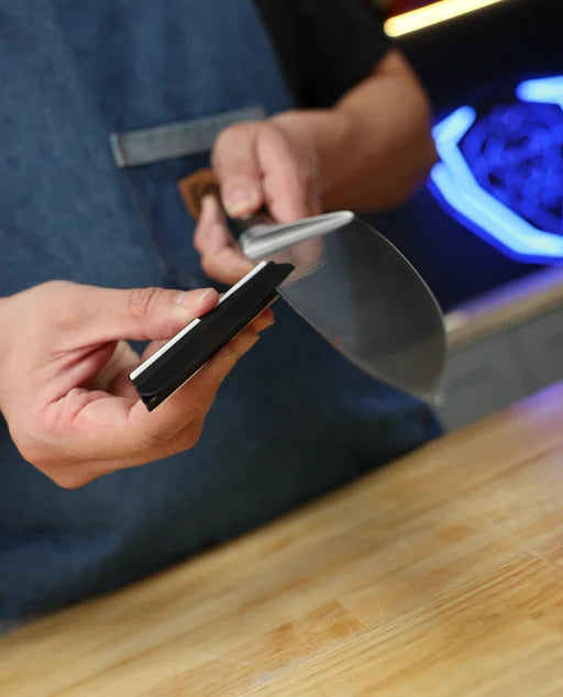 Fitting the 15-degree sharpening guide onto a knife blade