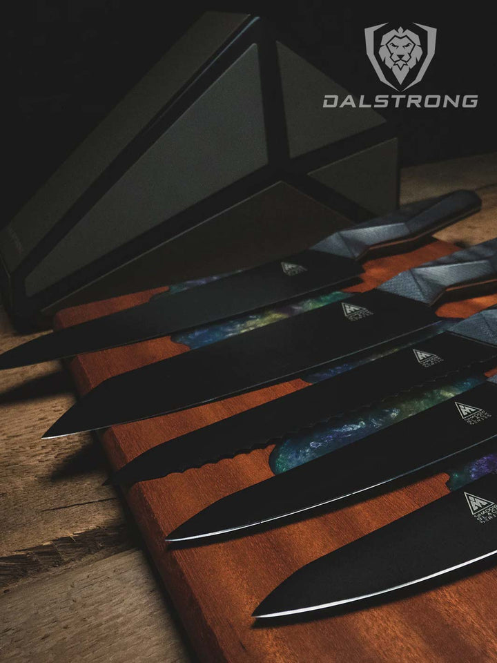 Dalstrong shadow black series 5 piece knife set with block on top of a wooden cutting board.
