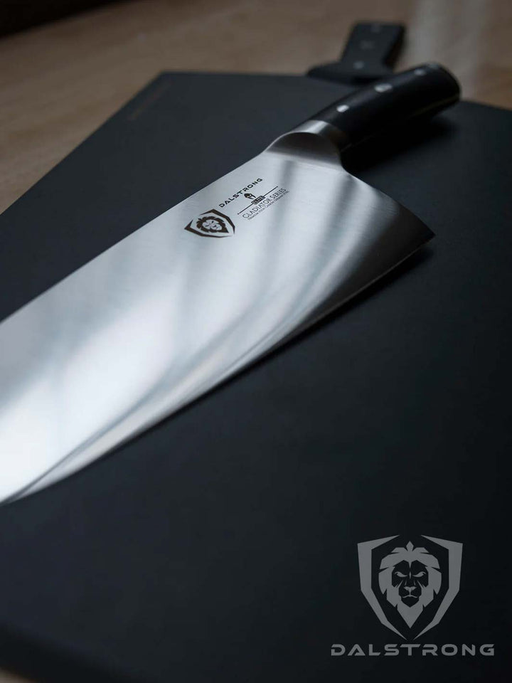 Dalstrong gladiator series 10 inch cleaver knife with black handle on top of a cutting board.