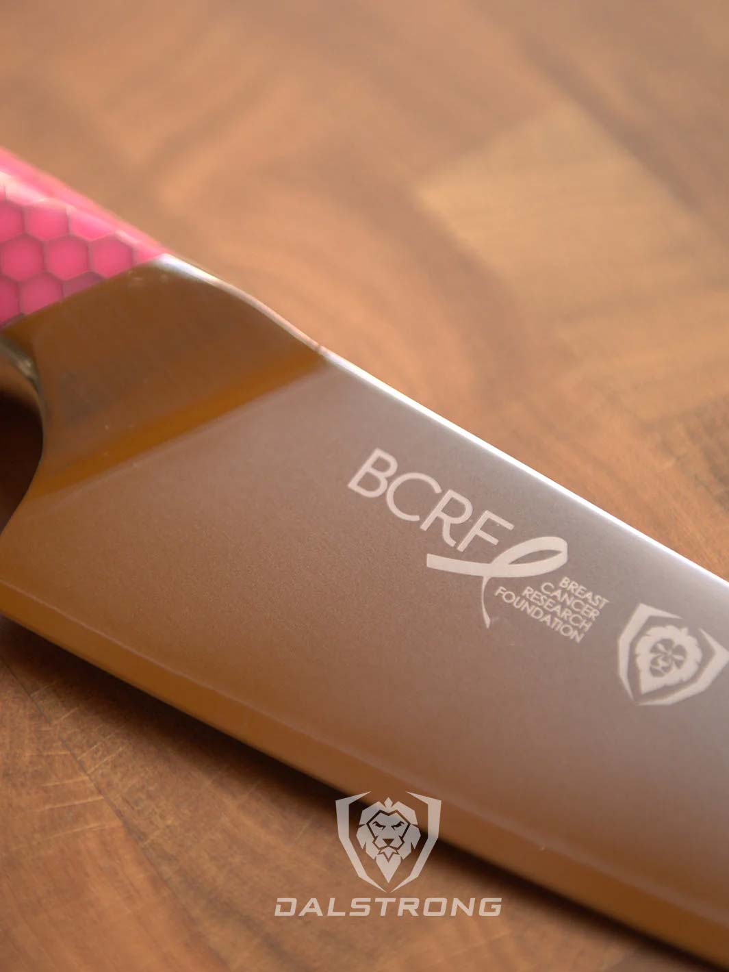 Dalstrong frost fire series 8 inch chef knife with pink handle showcasing it's blade.