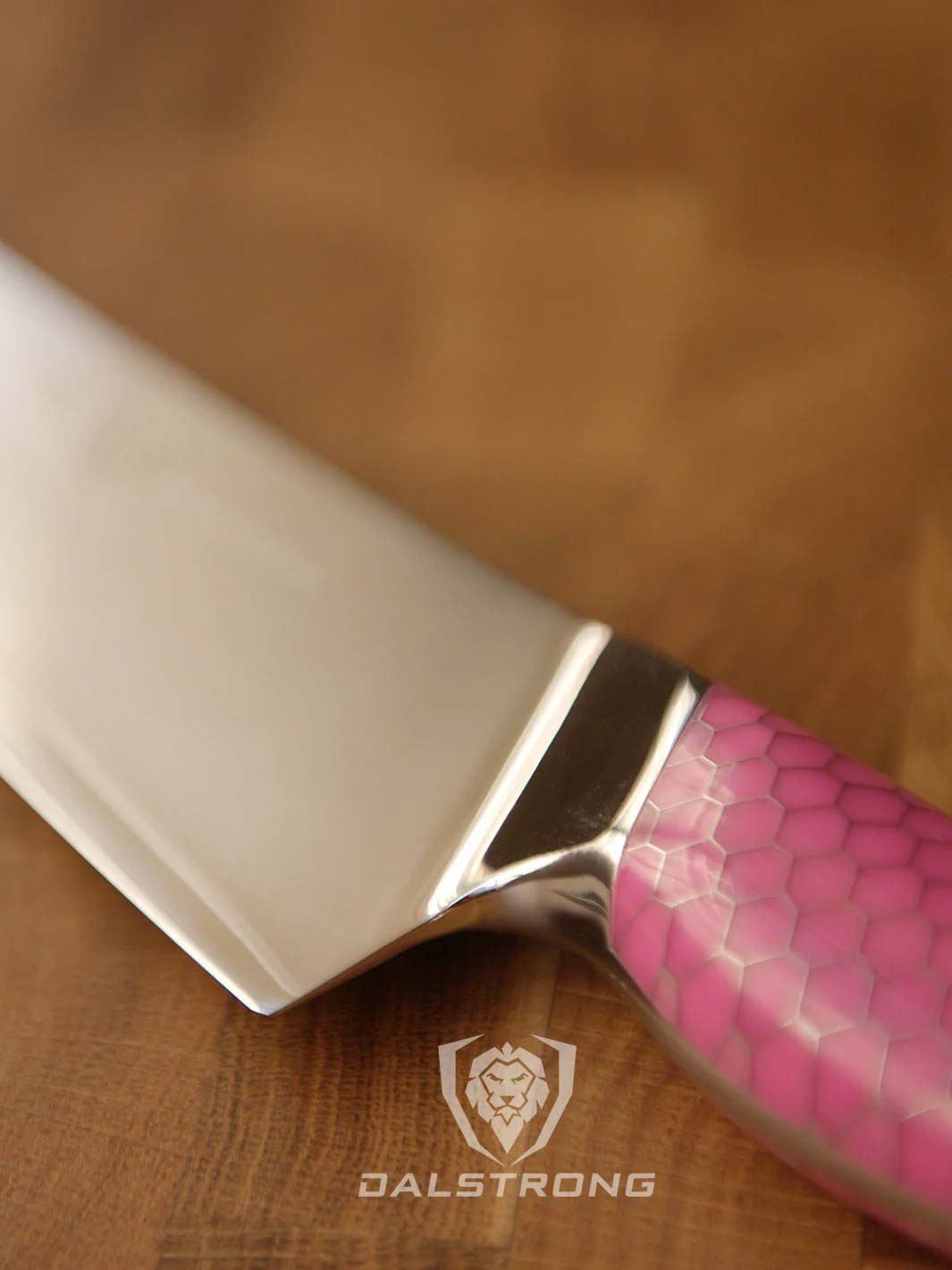 Dalstrong frost fire series 8 inch chef knife with pink handle featuring it's ergonomic handle.