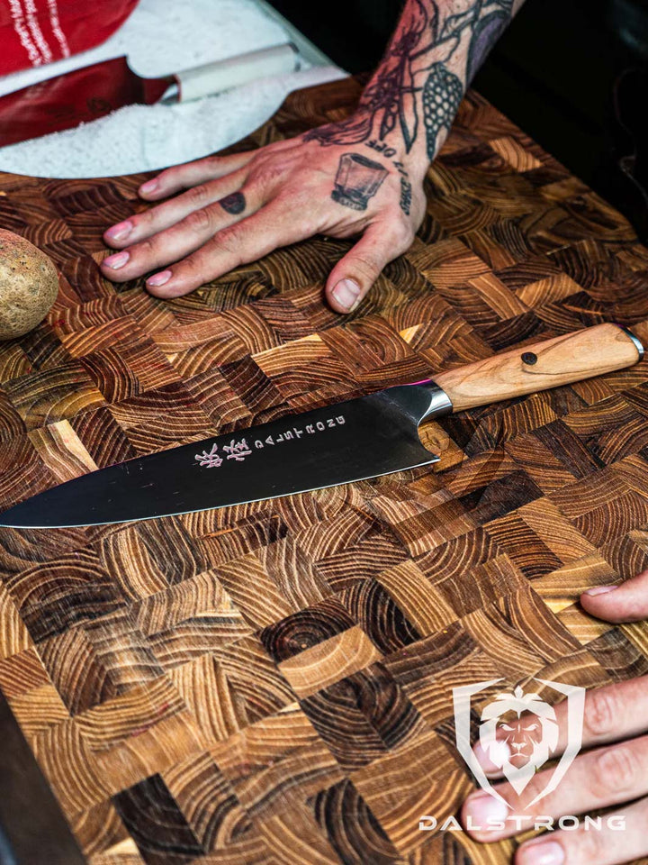 Dalstrong phantom series 8 inch chef knife with olive wood handle on a wooden cutting board.