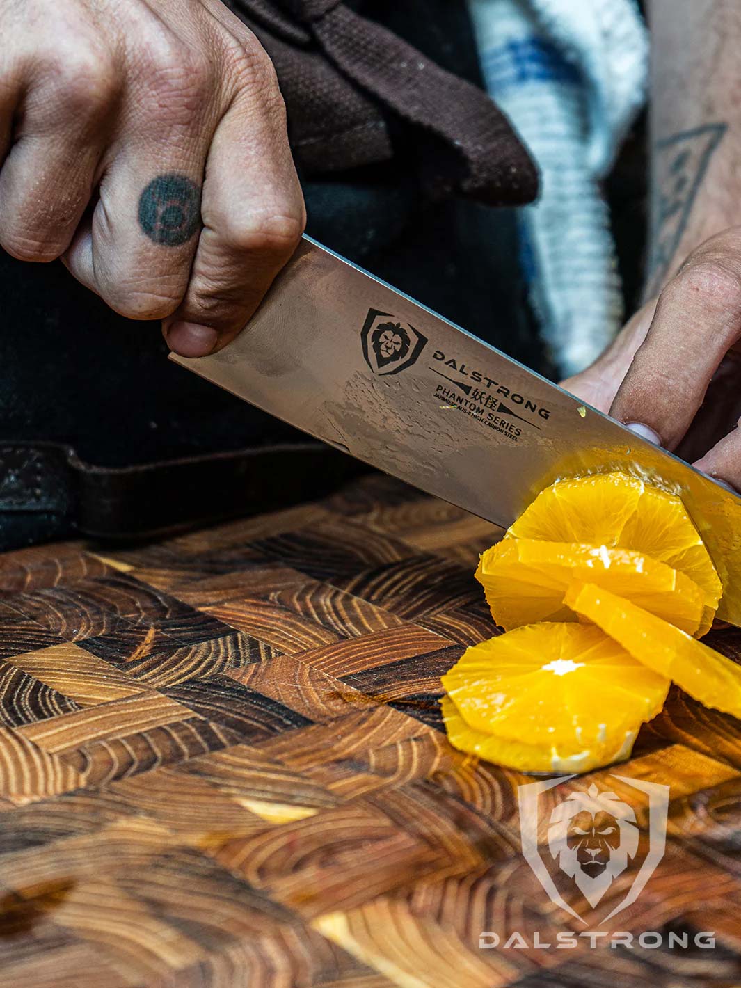 Dalstrong phantom series 8 inch chef knife with olive wood handle and slices of oranges on a cutting board.