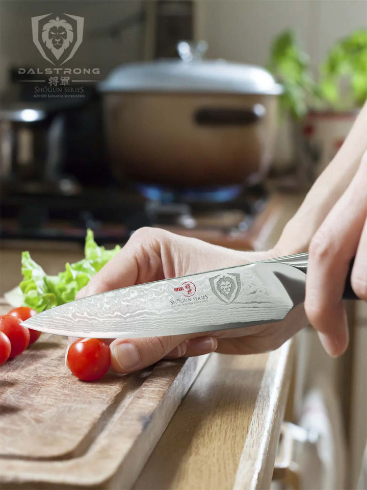 Dalstrong shogun series 3.5 inch paring knife with a small tomato on a wooden board.