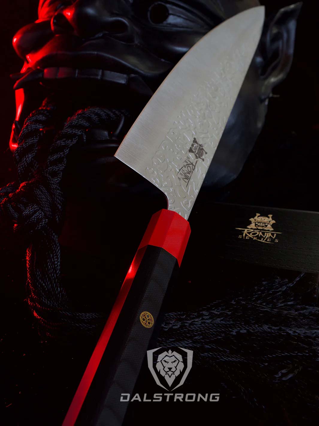 Dalstrong roning series 8 inch chef knife with black handle and sheath beside a samurai mask.