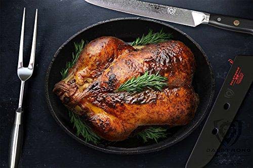 Dalstrong shogun series 9 inch carving knife with fork set and a roasted turkey on a pan.