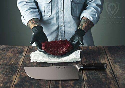 Dalstrong gladiator series 9 inch ravager cleaver knife beside a man holding a piece of meat.
