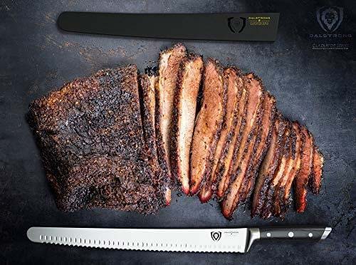Dalstrong gladiator series 14 inch serrated slicer knife with black handle and slices of brisket.