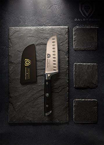 Dalstrong gladiator series 5 inch santoku knife with black handle and sheath on top of a black marble board.