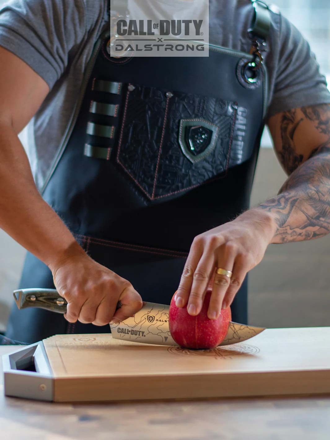 Dalstrong call of duty limited edition chef leather apron with an apple and cutting board.