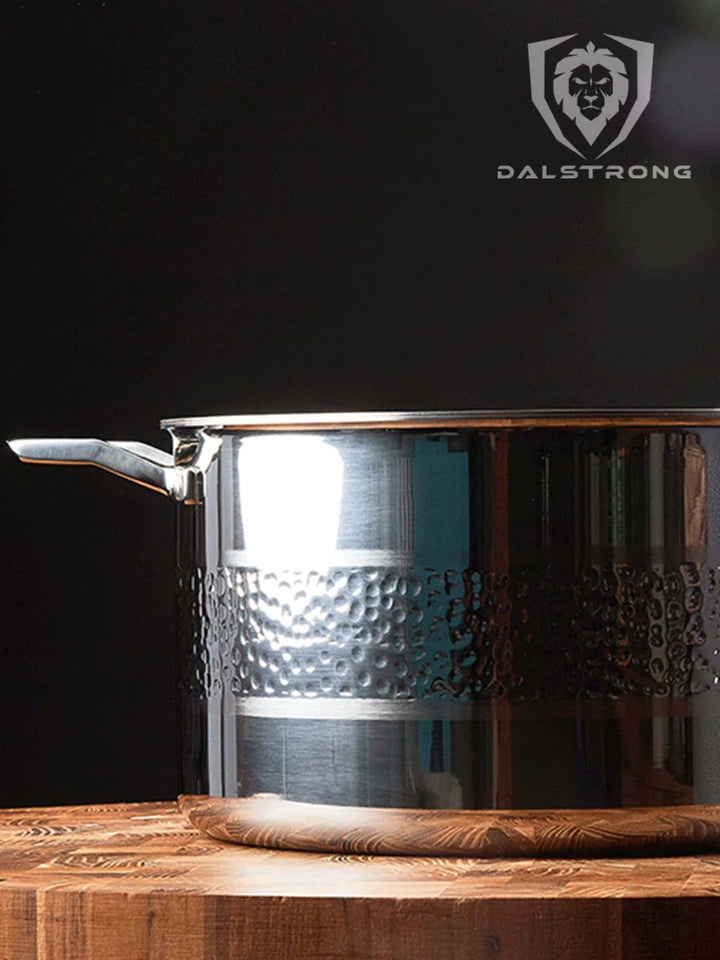 Dalstrong avalon series 5 quart stock pot hammered finish silver on a cutting board.