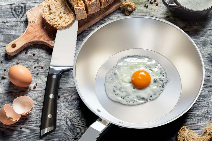 Dalstrong avalon series 9 inch frying pan skillet hammered finish silver with egg on it.