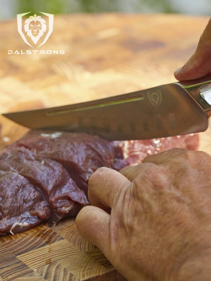 Dalstrong crusader series 6.5 inch fillet knife with slices of meat on a cutting board.
