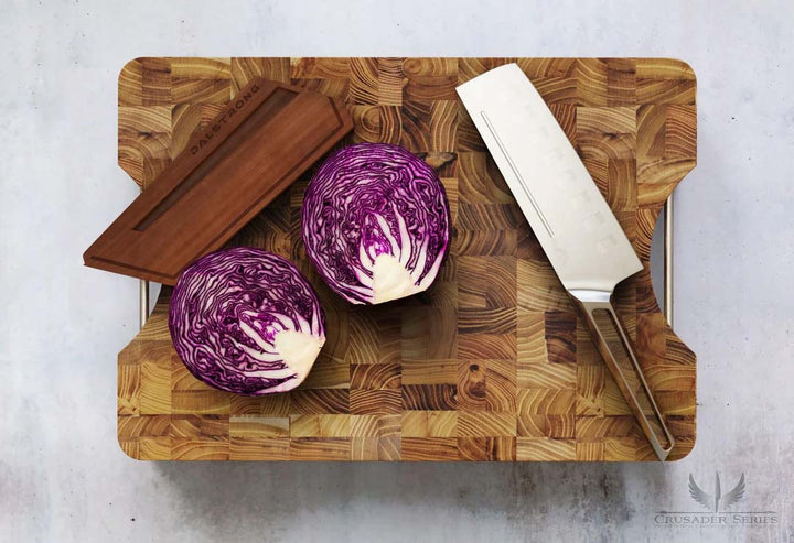 Dalstrong crusader series 7 inch nakiri knife with german steel handle and violet cabbage sliced in half on a cutting board.