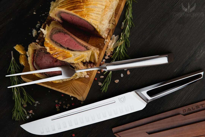 Dalstrong crusader series carving and fork set with slices of beef wellington.