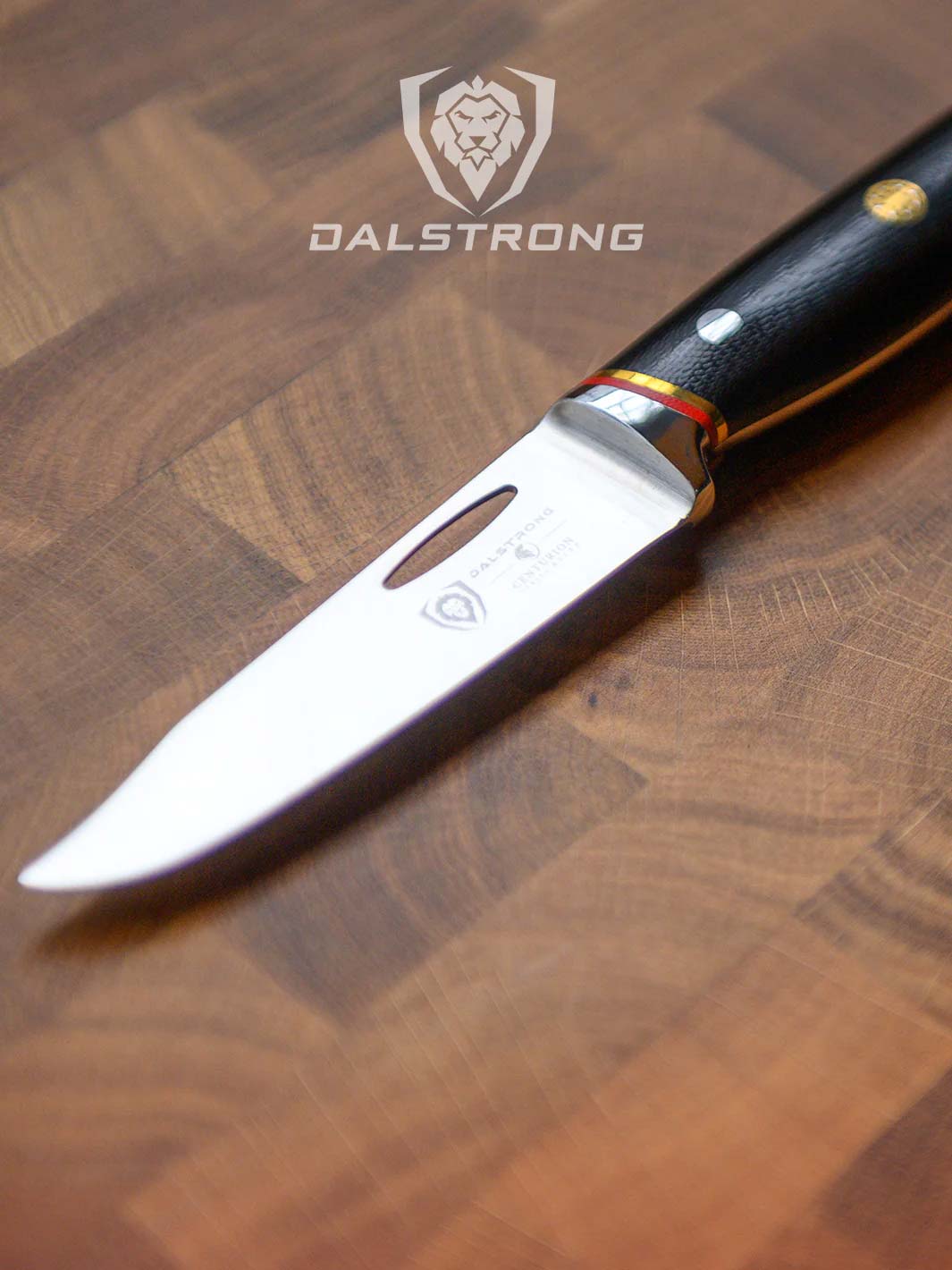 Dalstrong centurion series 3.5 inch paring knife with black handle on top of a cutting board.