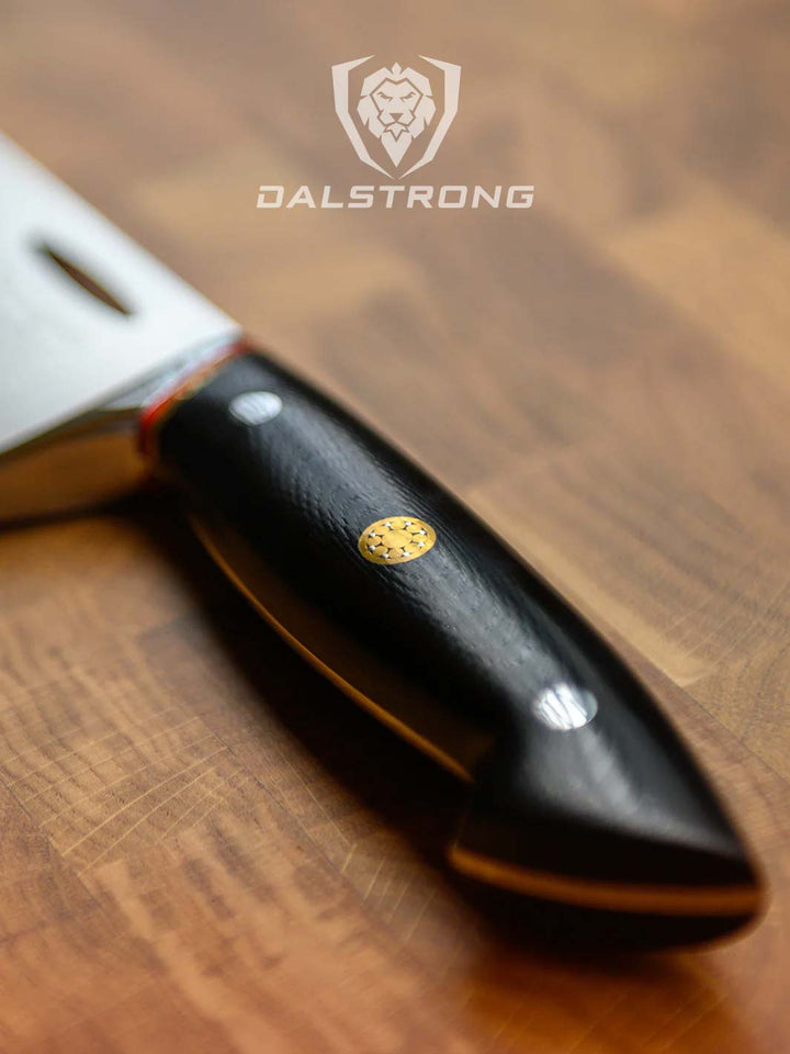 Dalstrong centurion series 7 inch santoku knife showcasing it's ergonomic black handle.