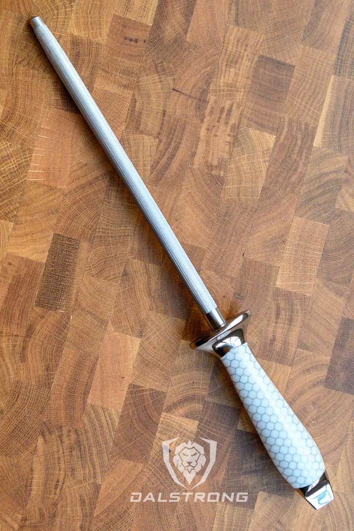 Dalstrong frost fire series 10 inch honing rod with white honeycomb handle on top of a wooden board.