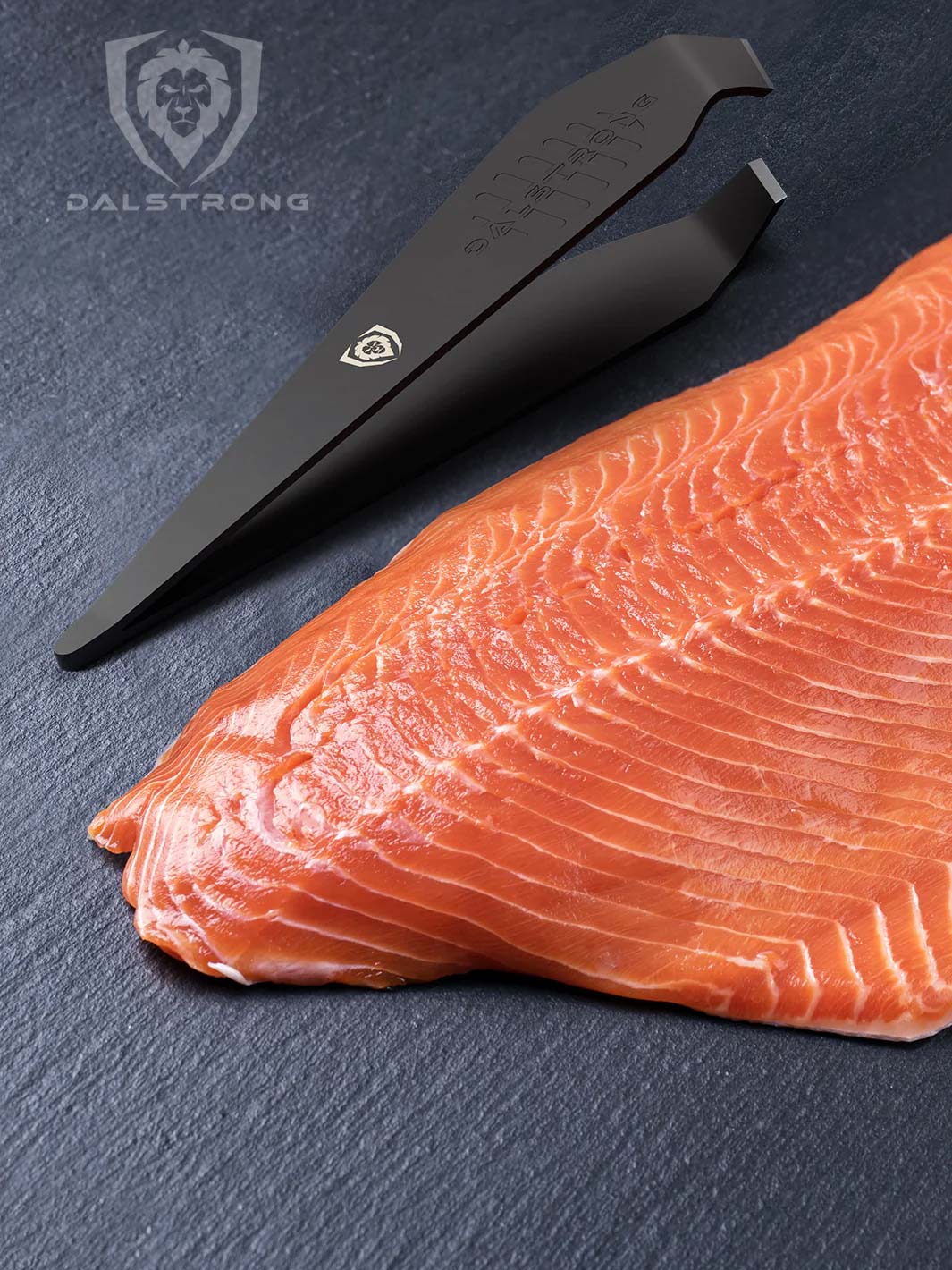 Dalstrong professional fish tweezers with black coating and a fillet of salmon beside it.