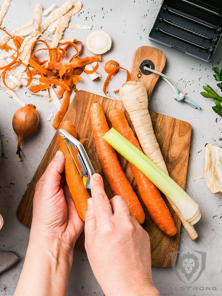 Dalstrong swivel straight peeler with 3 blades in a case with peeled carrots.