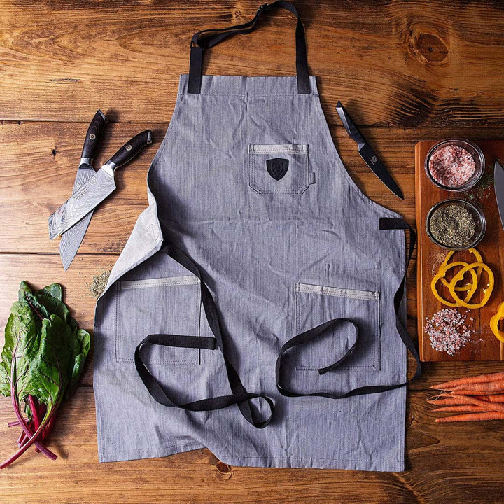 Dalstrong the gandalf professional chef's kitchen apron with knives at the side.