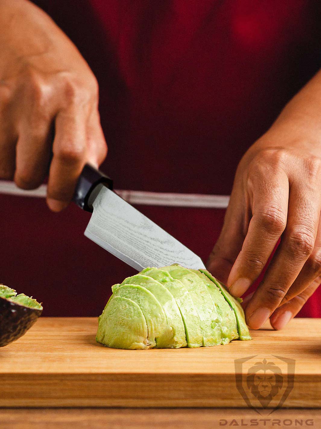 Dalstrong firestorm alpha series 3.75 inch paring knife with a peeled and sliced avocado on a cutting board.