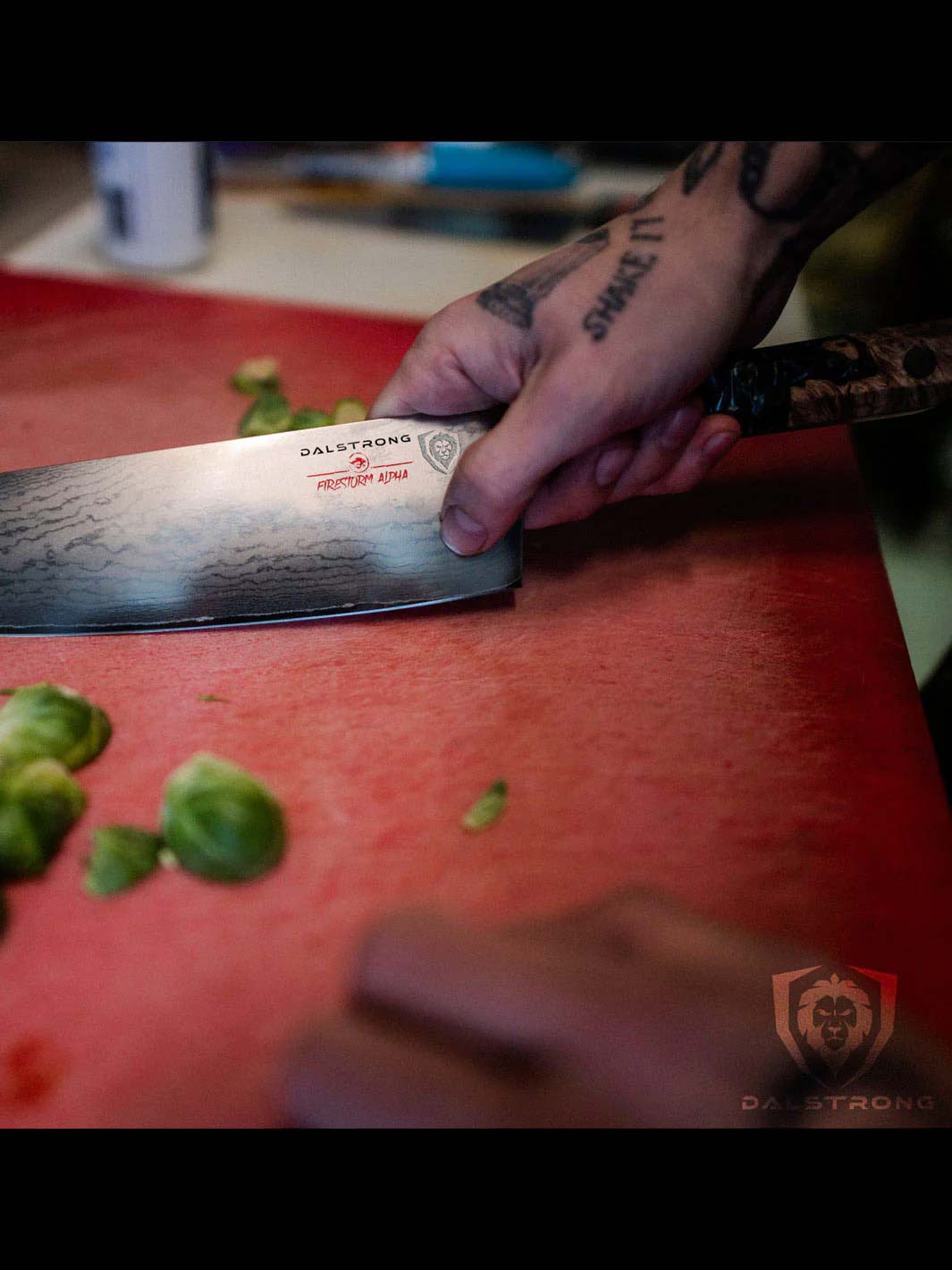 Dalstrong firestorm alpha series 9.5 inch chef knife with brussel sprouts on a red cutting board.