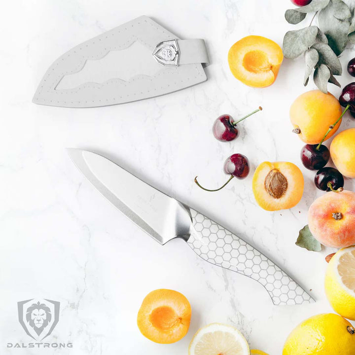 Dalstrong frost fire series 3.5 inch paring knife with peaches cut in half.