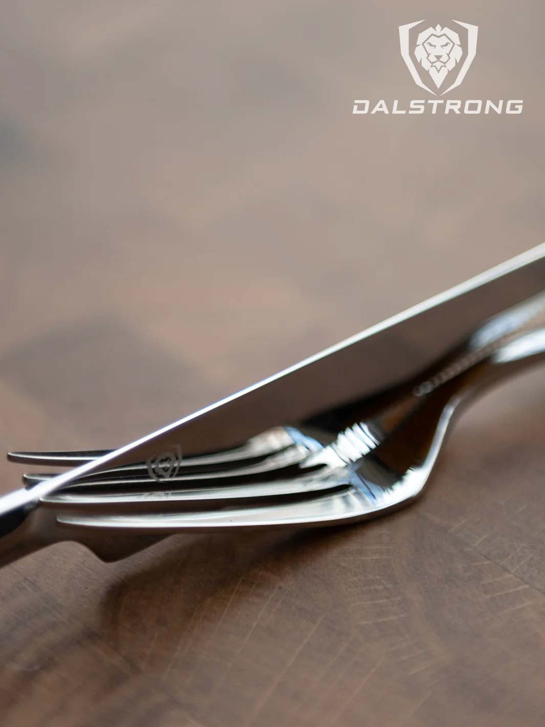 Dalstrong 20 piece flatware cutlery set silver stainless steel service for 4 on top of a cutting board.