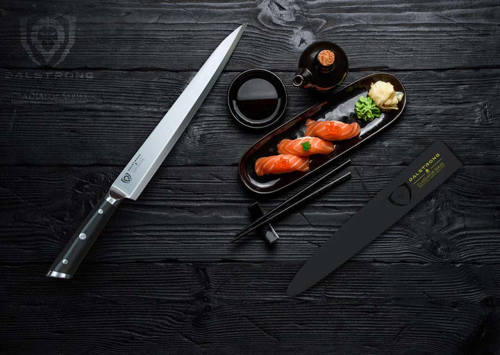 Dalstrong gladiator series 10.5 inch yanagiba knife with black handle and sheath beside a tuna sushi.