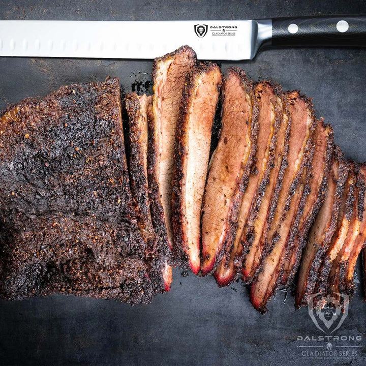 Dalstrong gladiator series 10 inch slicer knife with black handle and slices of smoked brisket.
